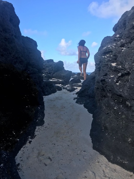 Priya exploring rocky area on beach